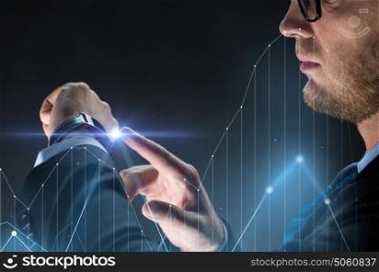 business, people and modern technology concept - close up of businessman with smartwatch and diagram chart virtual projection over black background. close up of businessman with smartwatch