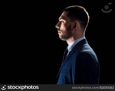 business, people and office concept - buisnessman in suit over black background. buisnessman in suit over black