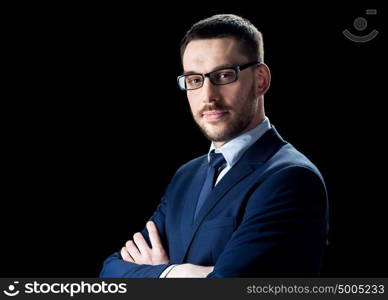 business, people and office concept - businessman in glasses over black background. businessman in glasses over black