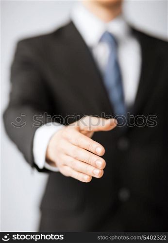 business people and office concept - businessman with open hand ready for handshake