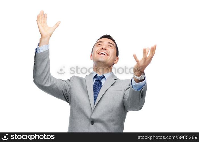 business, people and office concept - happy businessman in suit with raised hands laughing and looking up
