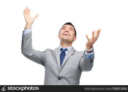 business, people and office concept - happy businessman in suit with raised hands laughing and looking up