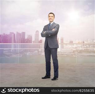 business, people and office concept - happy smiling businessman in dark grey suit over singapore city background