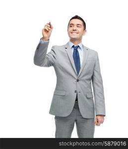 business, people and office concept - happy smiling businessman in suit writing or drawing something imaginary with marker