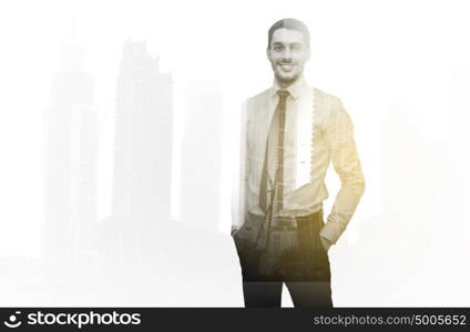 business, people and office concept - happy smiling businessman over city and double exposure effect. happy smiling businessman