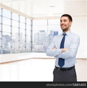 business, people and office concept - happy young buisnessman over office room or new apartment background