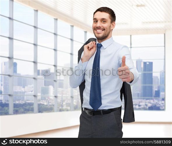 business, people and office concept - happy young businessman showing thumbs up over office room or new apartment background