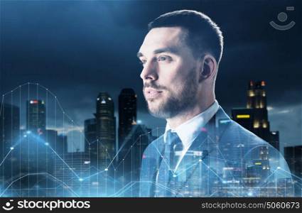 business, people and statistics concept - businessman in suit over night singapore city skyscrapers background and diagram charts. businessman over night city and diagram charts
