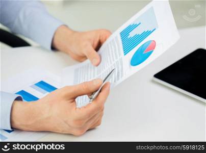 business, people and statistics concept - close up of businessman hands with chart and pen at office