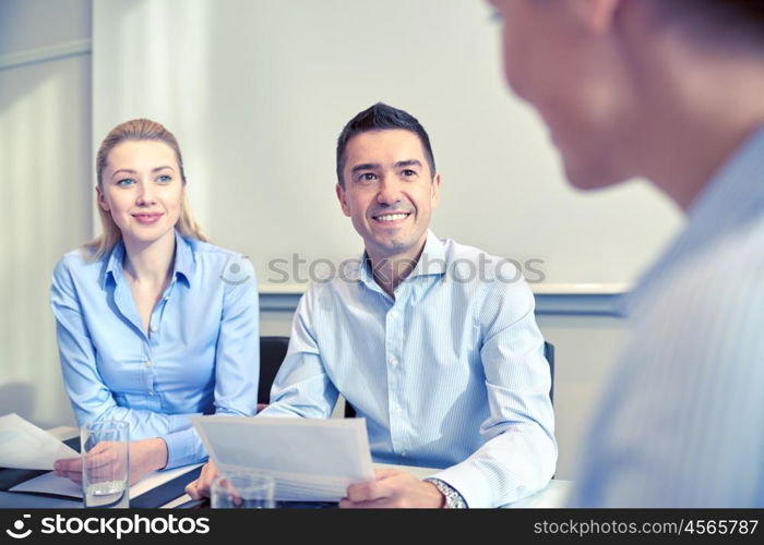 business, people and teamwork concept - group of smiling businesspeople meeting in office