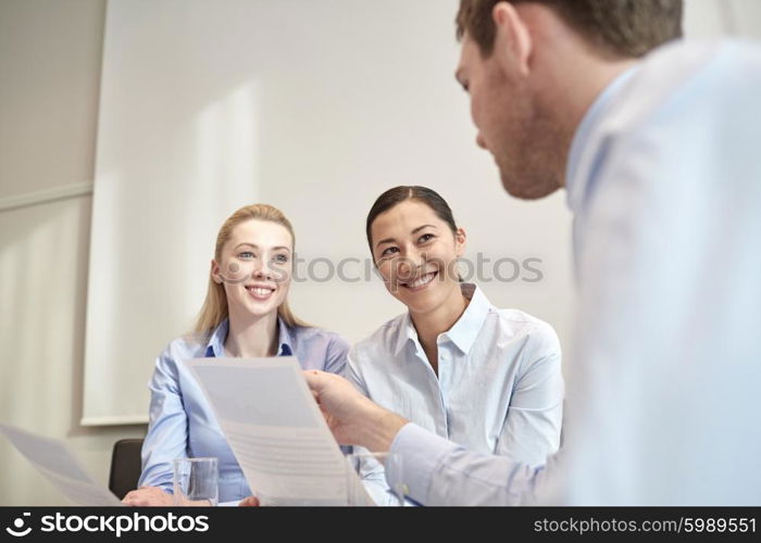 business, people and teamwork concept - group of smiling businesspeople meeting in office