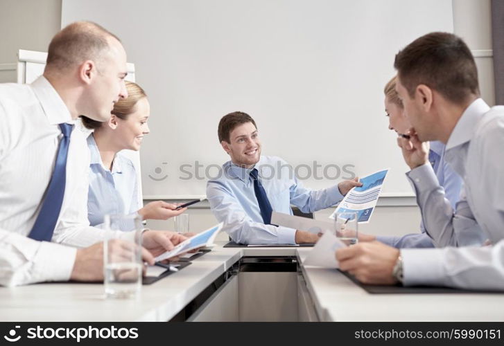 business, people and teamwork concept - group of smiling businesspeople meeting in office