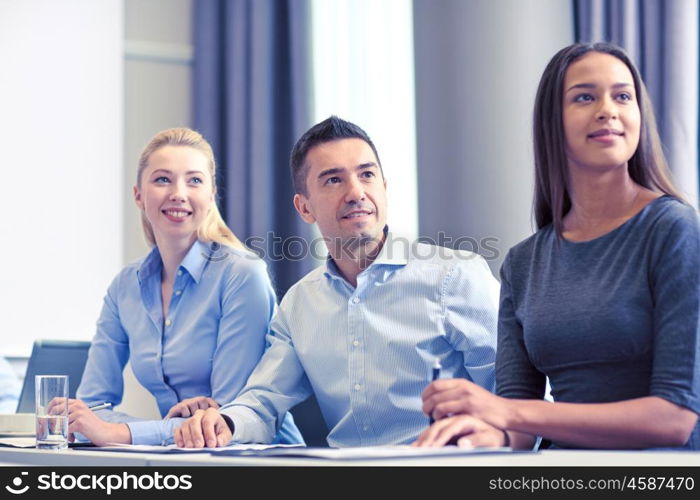 business, people and teamwork concept - group of smiling businesspeople meeting on presentation in office