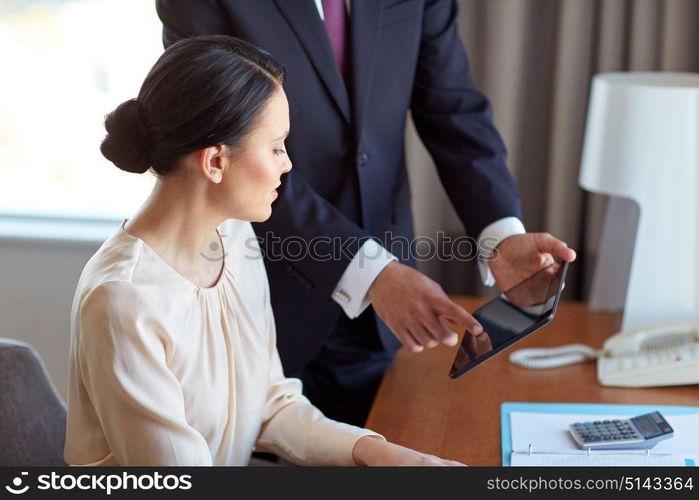 business, people and teamwork concept - man and woman with tablet pc computer working at hotel room. business team with tablet pc working at hotel room