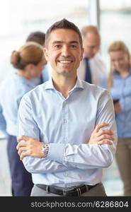 business, people and teamwork concept - smiling businessman with group of businesspeople meeting in office