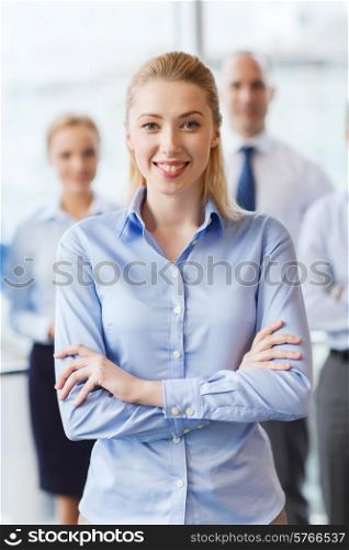 business, people and teamwork concept - smiling businesswoman with group of businesspeople in office