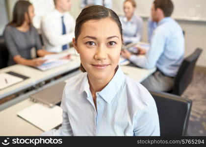 business, people and teamwork concept - smiling businesswoman with group of businesspeople meeting in office