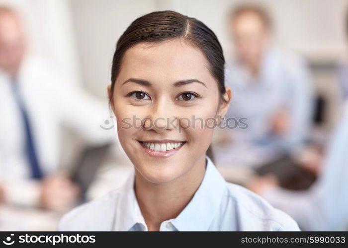 business, people and teamwork concept - smiling businesswoman with group of businesspeople meeting in office