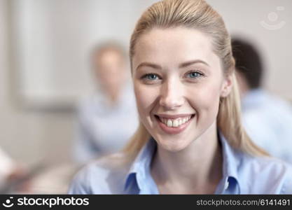 business, people and teamwork concept - smiling businesswoman with group of businesspeople meeting in office