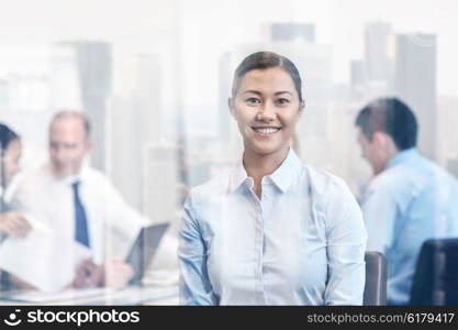 business, people and teamwork concept - smiling businesswoman with group of businesspeople meeting in office