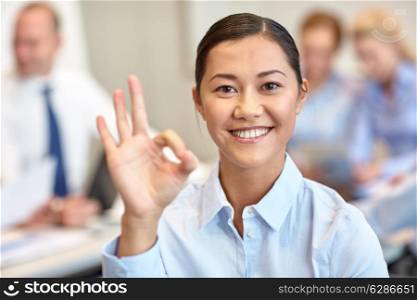 business, people and teamwork concept - smiling businesswoman with group of businesspeople meeting in office