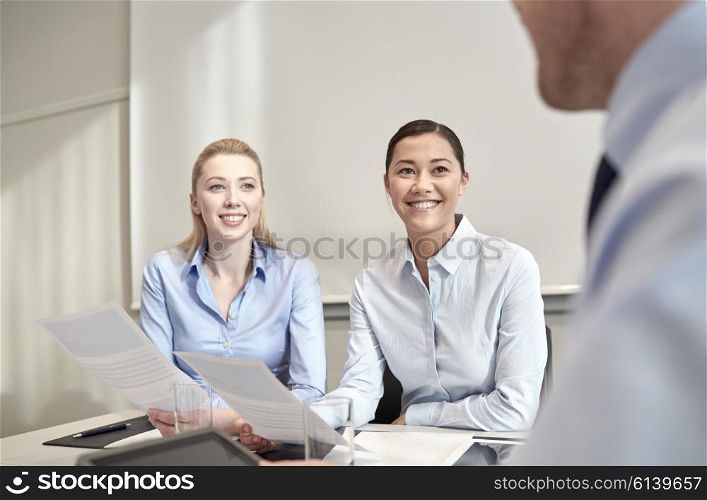 business, people and teamwork concept - smiling businesswomen meeting in office
