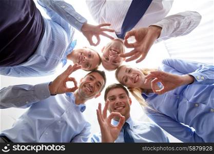 business, people and teamwork concept - smiling group of businesspeople standing in circle