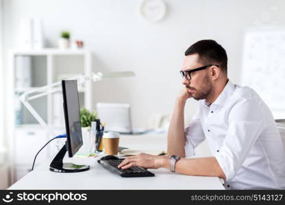 business, people and technology concept - businessman in glasses typing on computer keyboard at office. businessman typing on computer keyboard at office