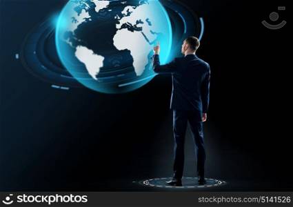 business, people and technology concept - businessman in suit touching earth globe hologram over black background. businessman in suit touching earth globe hologram