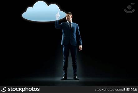 business, people and technology concept - businessman in suit touching virtual cloud hologram over black background. businessman touching virtual cloud hologram
