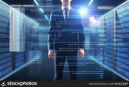 business, people and technology concept - businessman in suit with coding on virtual screen over server room background. businessman with coding on virtual screen