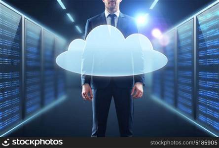 business, people and technology concept - businessman in suit with virtual cloud hologram over server room background. businessman in suit with virtual cloud hologram