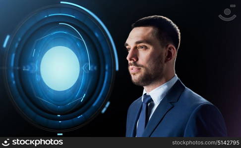 business, people and technology concept - businessman in suit with virtual projection over black background. businessman with virtual projection over black