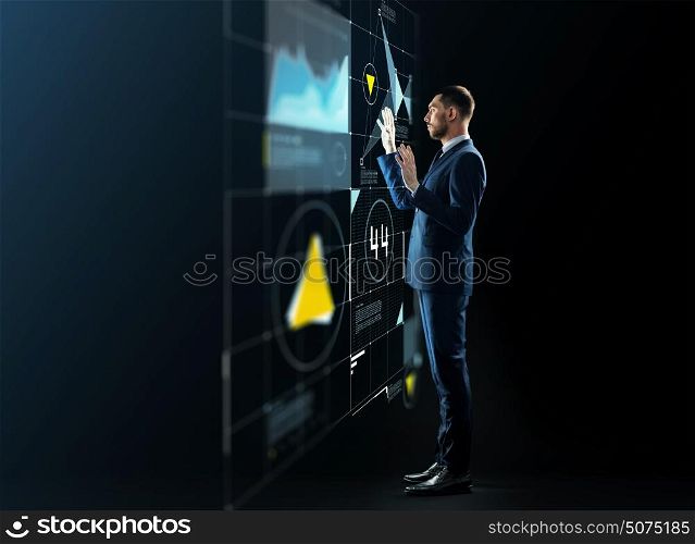 business, people and technology concept - businessman in suit working with virtual projection over black background. businessman working with virtual projection