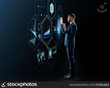 business, people and technology concept - businessman in suit working with virtual projection over black background. businessman working with virtual projection