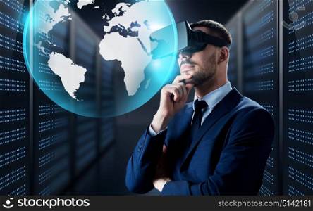 business, people and technology concept - businessman in virtual reality headset with earth globe projection over futuristic server room background. businessman in virtual reality headset with globe