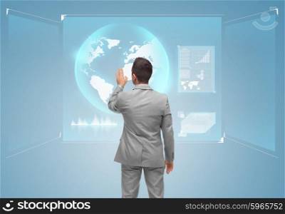 business, people and technology concept - businessman touching virtual screen with globe from back over blue background