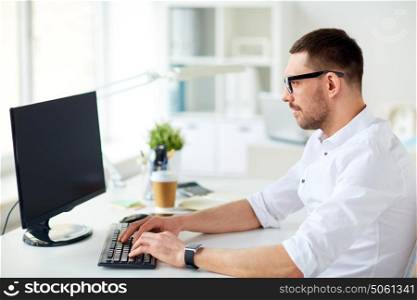 business, people and technology concept - businessman typing on computer keyboard at office. businessman typing on computer keyboard at office