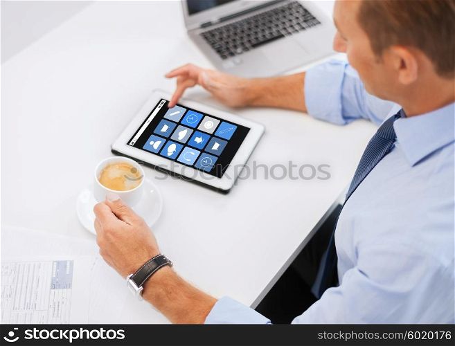 business, people and technology concept - businessman with application icons on tablet pc drinking coffee in office