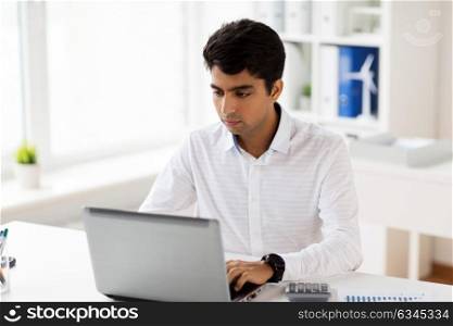 business, people and technology concept - businessman with laptop computer and papers working at office. businessman with laptop working at office