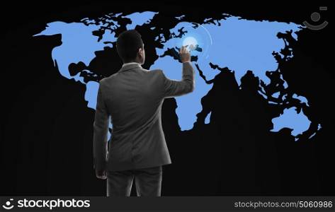 business, people and technology concept - businessman with marker and virtual world map from back over black background. businessman working with virtual world map