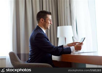 business, people and technology concept - businessman with tablet pc computer and papers working at hotel room. businessman with tablet pc working at hotel room