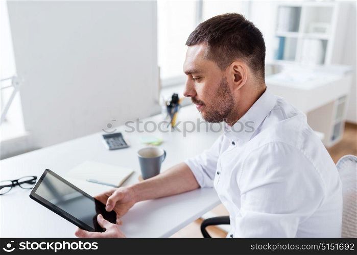 business, people and technology concept - businessman with tablet pc computer at office. businessman with tablet pc at office
