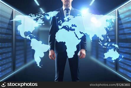 business, people and technology concept - businessman with virtual world map projection over server room background. businessman with world map projection in corridor