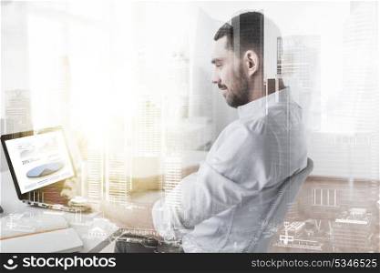 business, people and technology concept - businessman working on laptop computer with charts on screen at office with double exposure effect. businessman with charts on laptop screen at office