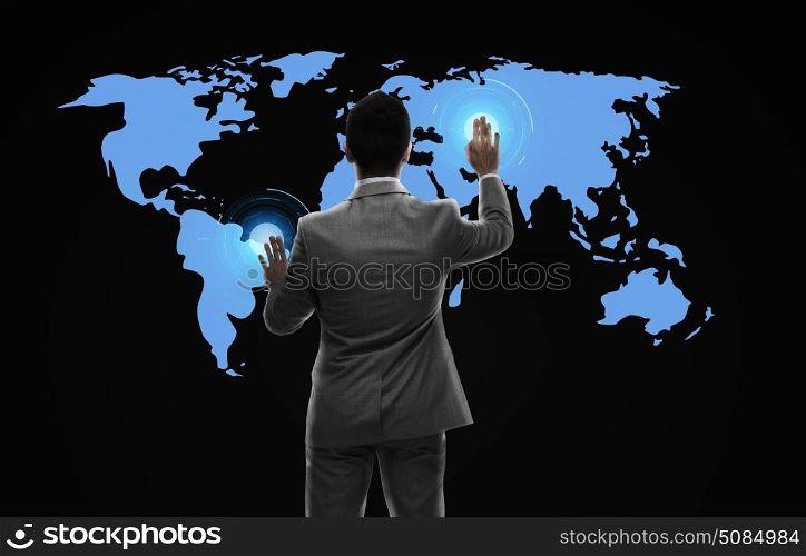business, people and technology concept - businessman working with virtual world map from back over black background. businessman working with virtual world map. businessman working with virtual world map