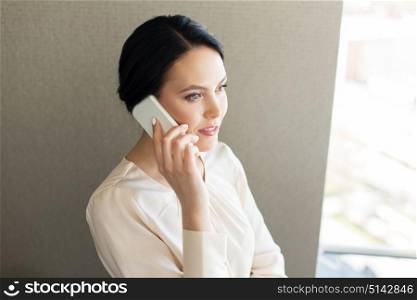 business, people and technology concept - businesswoman calling on smartphone. businesswoman calling on smartphone