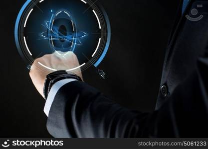 business, people and technology concept - close up of businessman hand with smartwatch and virtual projection over black background. close up of businessman hand with smartwatch