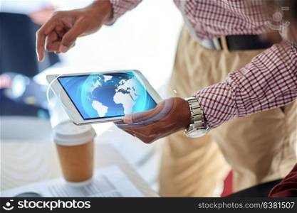 business, people and technology concept - close up of businessman with earth hologram over tablet pc computer at office. businessman with tablet pc and earth hologram
