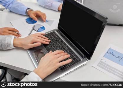 business, people and technology concept - close up of businesspeople with laptop at office. close up of businesspeople with laptop at office